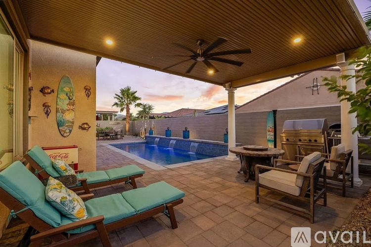 A poolside patio with a Coca-Cola mural on the wall.