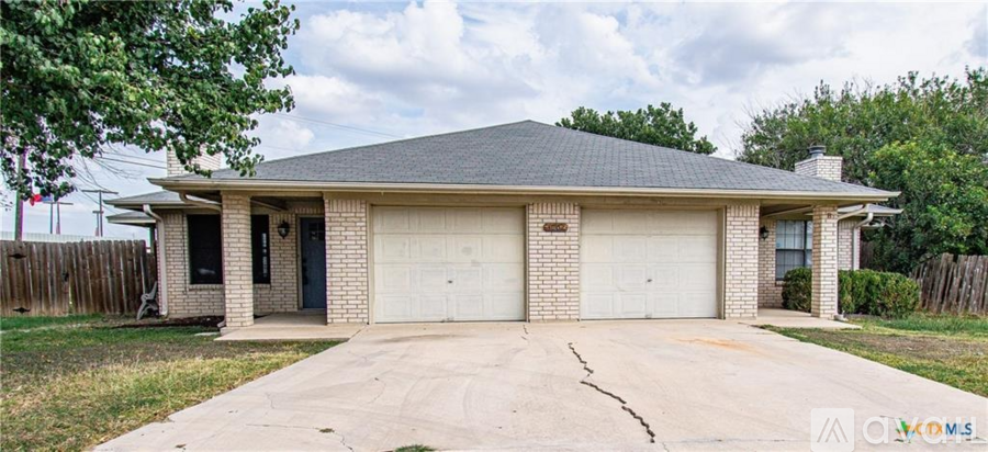 A two-car garage with a brick exterior and a gabled roof.
