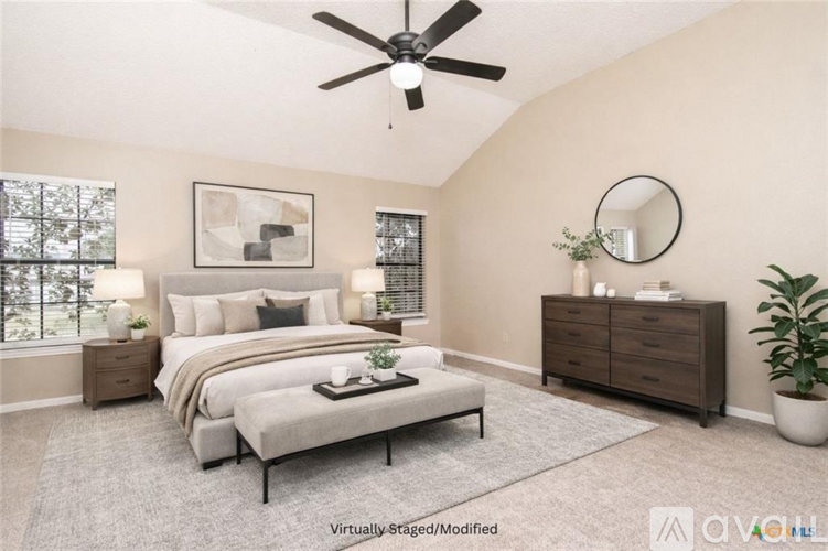 A bedroom with a large bed, a dresser, and a mirror.