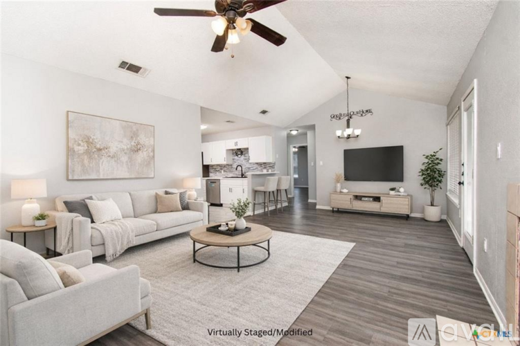 A living room with a grey couch and a coffee table.