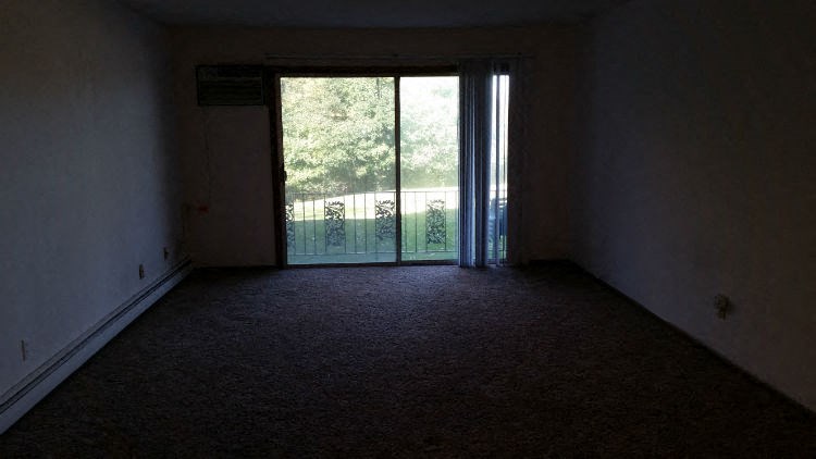 an empty room with a sliding glass door