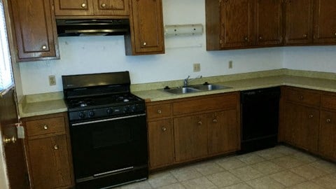a kitchen with a black stove and a sink