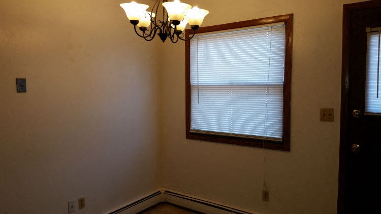 a living room with a window and a chandelier