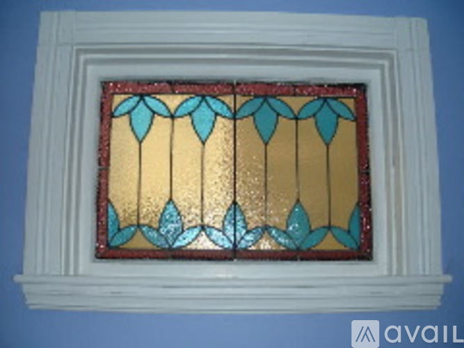 A stained glass window with a white frame.