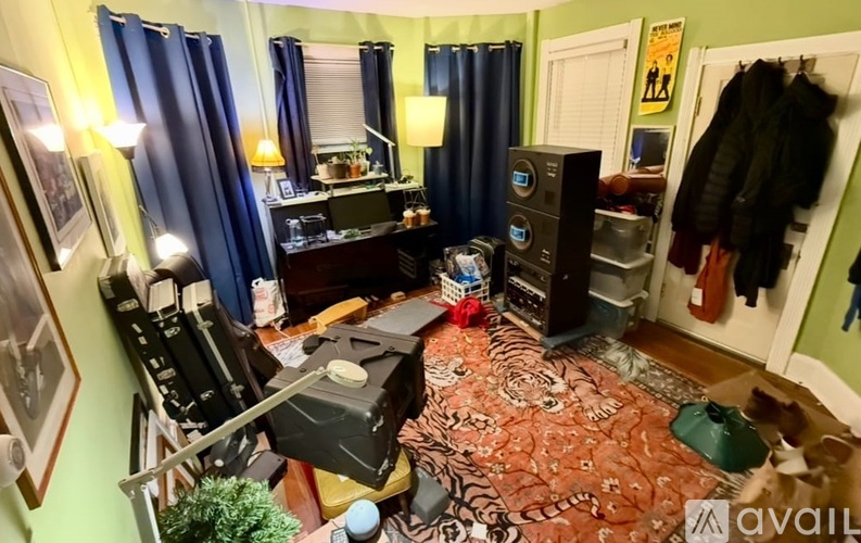 A room with a rug on the floor and a black chair.