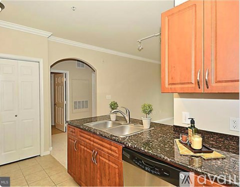 A kitchen with wooden cabinets and a granite countertop.
