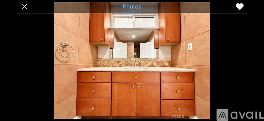 A kitchen with wooden cabinets and a tiled backsplash.