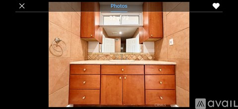 A kitchen with wooden cabinets and a tiled backsplash.