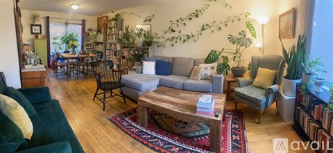 A living room with a green couch and a wooden coffee table.
