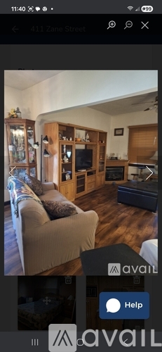 A living room with a couch, a television, and a cabinet.