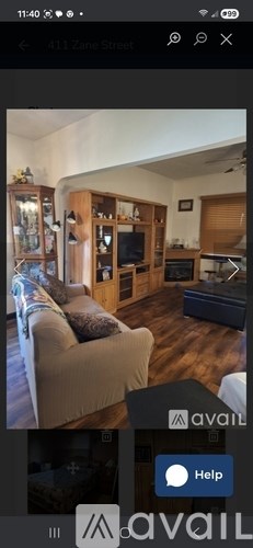 A living room with a couch, a television, and a cabinet.