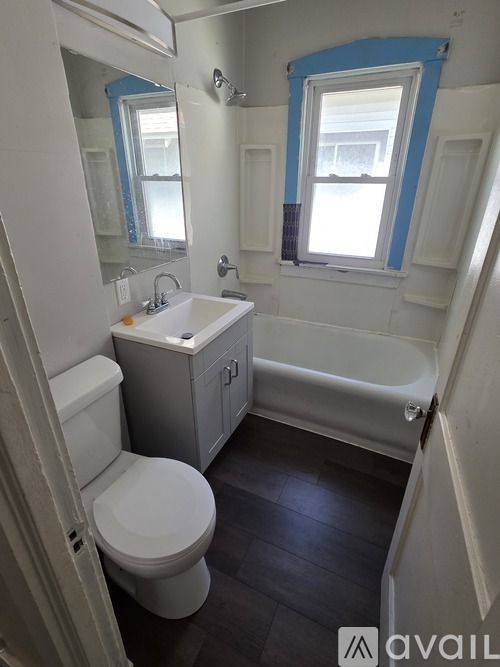 A bathroom with a toilet, sink, and bathtub.