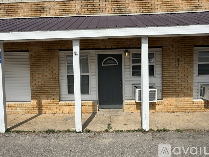 A house with a black door and white columns.