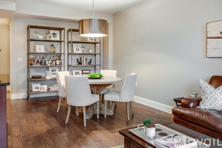 A modern dining room with a wooden table and chairs.