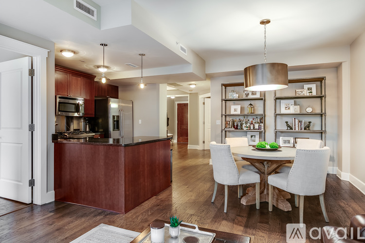 A modern kitchen with a dining table set for two.