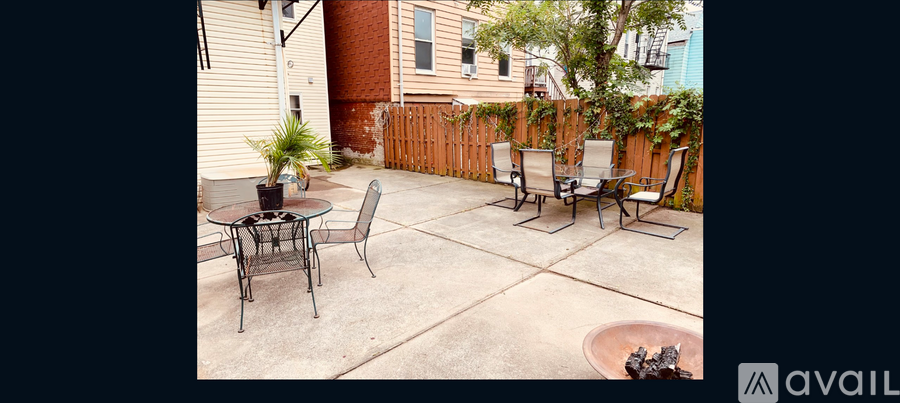 A patio with a table and chairs.