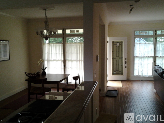 A living room with a brown table and chairs.