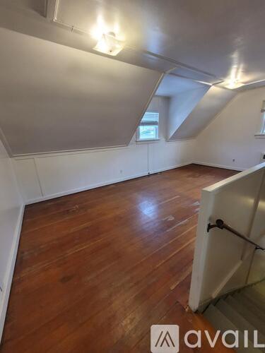 A room with wooden floors and white walls.