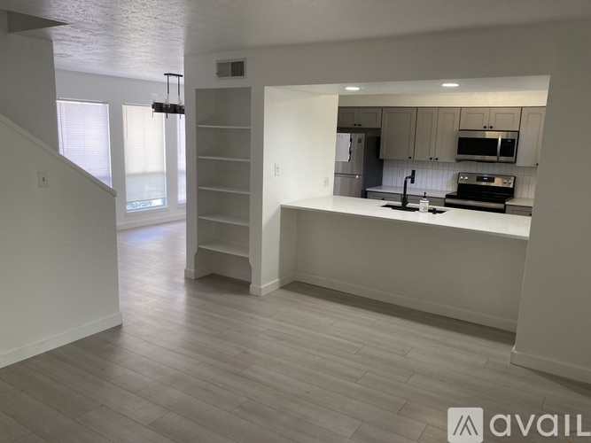 A modern kitchen with white cabinets and a large island.