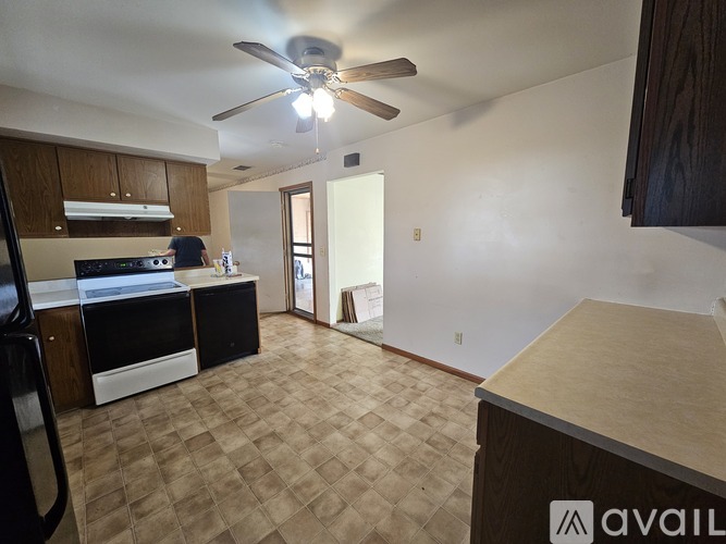 A kitchen area with a fan and a countertop.