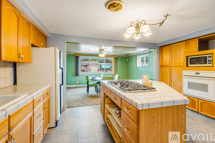 A kitchen with wooden cabinets and a white countertop.