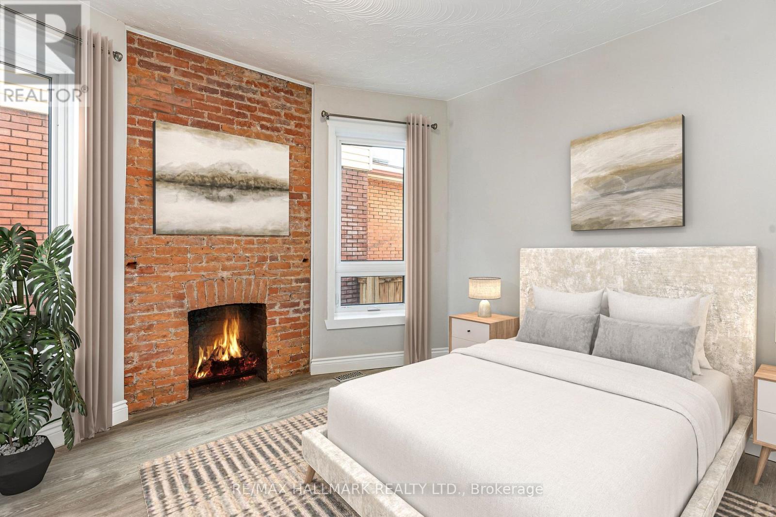A bedroom with a fireplace and a bed.