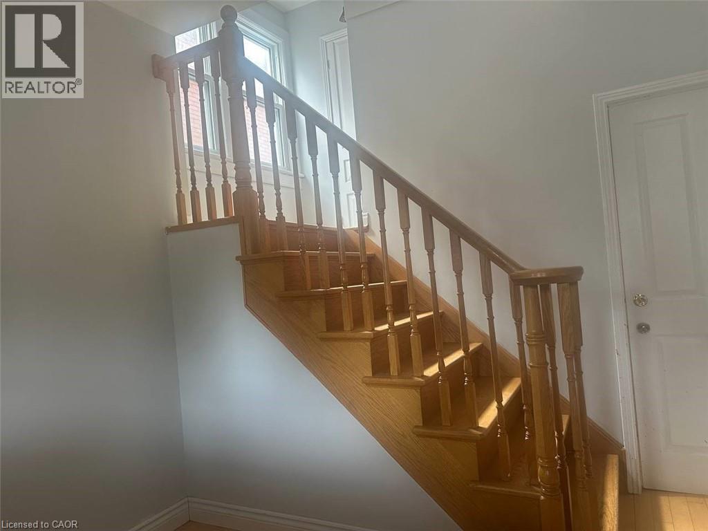 A wooden staircase with a white door at the top.