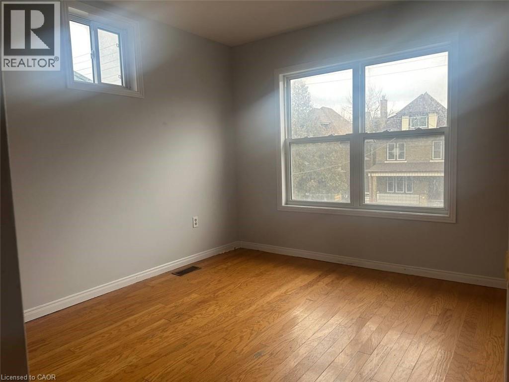 A room with a window overlooking a building.