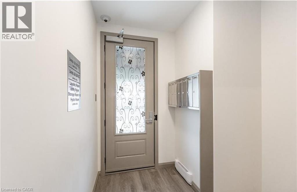 A hallway with a door and a sign on the wall.