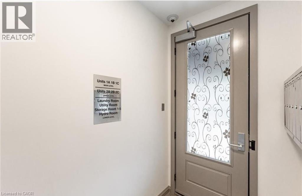 A door with a glass window and a sign on the wall.