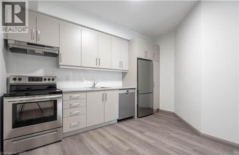 A modern kitchen with stainless steel appliances and white cabinets.