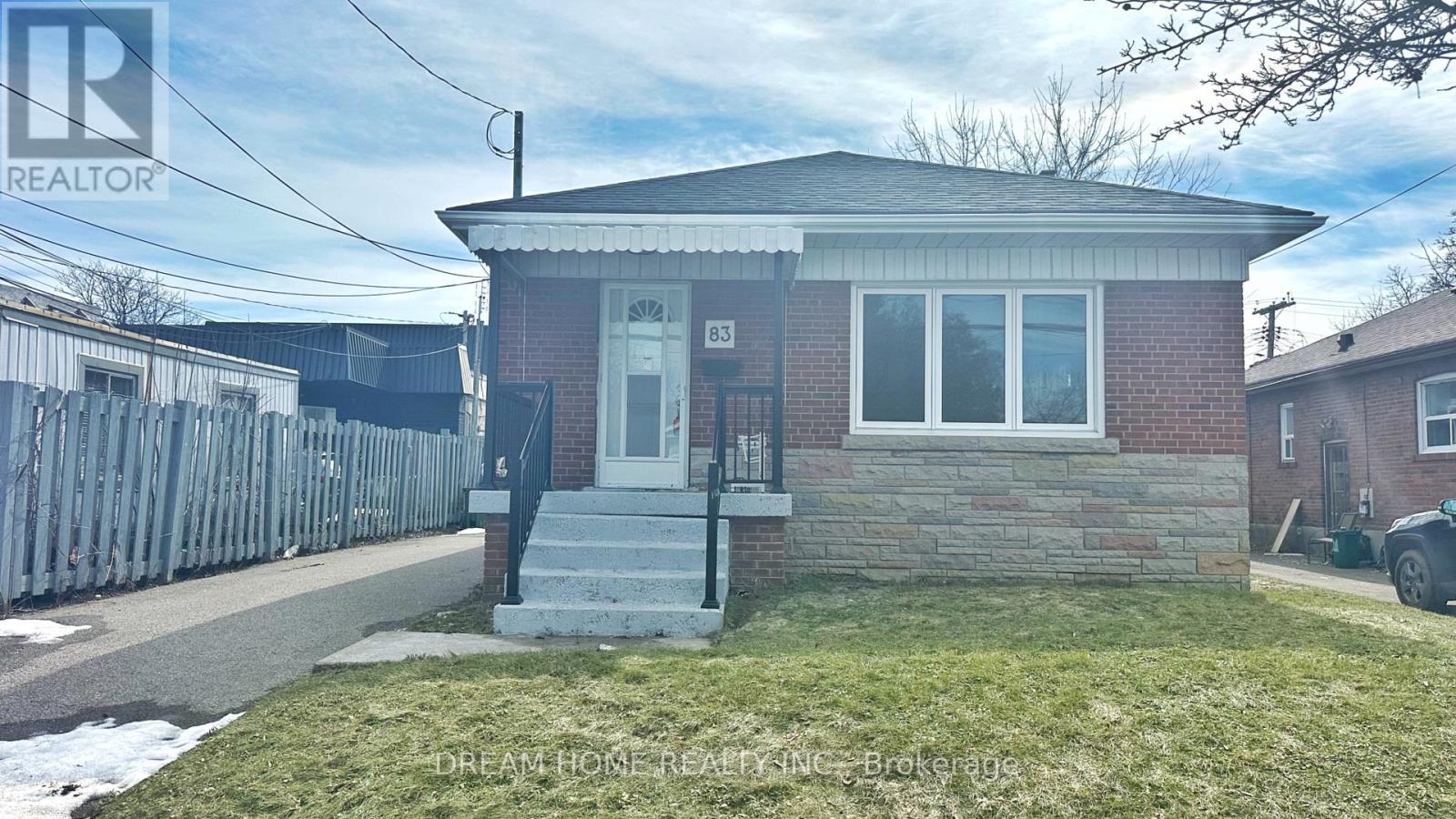 A house with a brick facade and a white door is for sale.