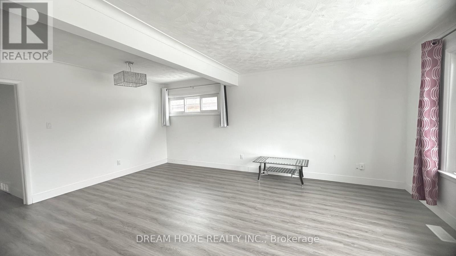 A room with a bench and a window.
