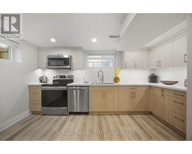 A kitchen with wooden cabinets and stainless steel appliances.