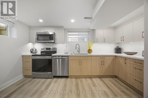 A kitchen with wooden cabinets and stainless steel appliances.