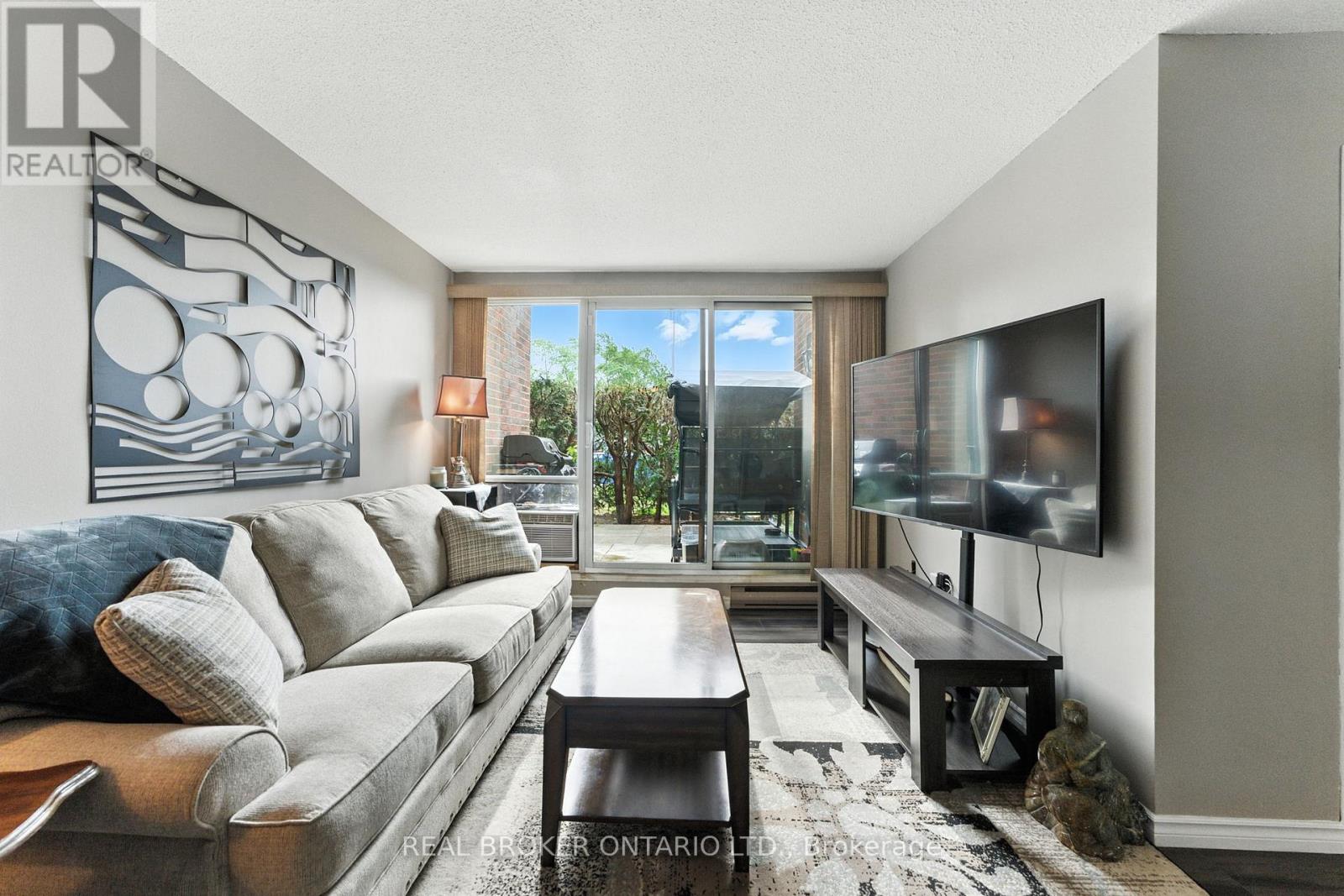 A living room with a grey couch and a television.