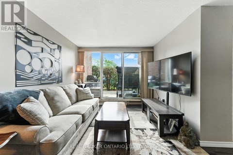 A living room with a grey couch and a television.