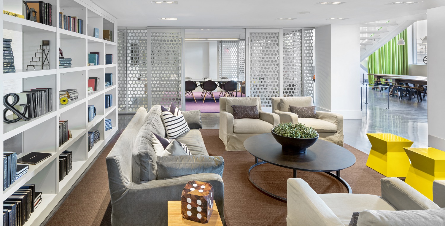 a living room with couches and chairs and a table