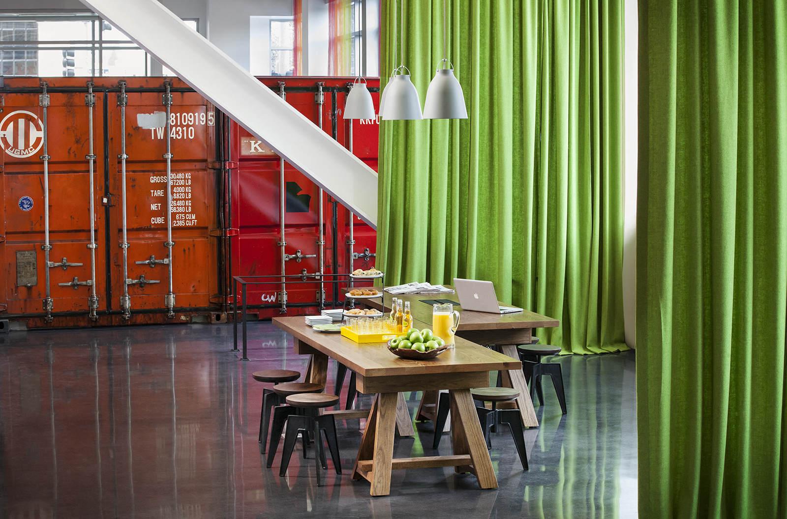 a dining room with green curtains and a wooden table and chairs