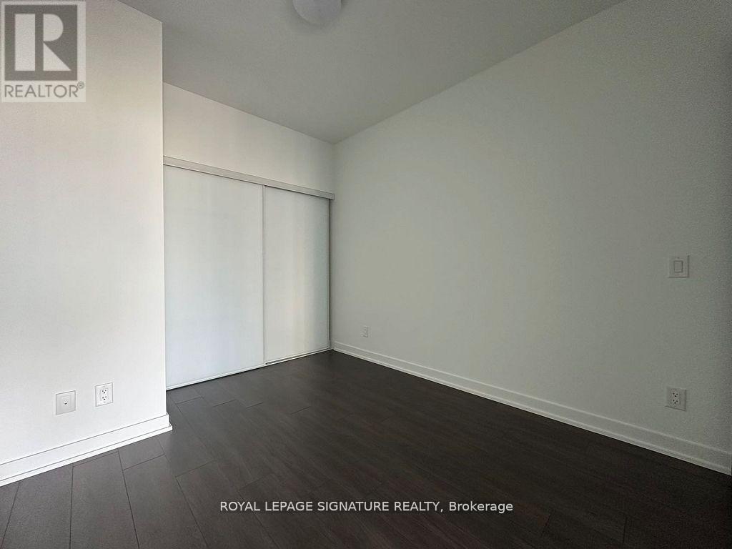 A room with a sliding door and wooden flooring.