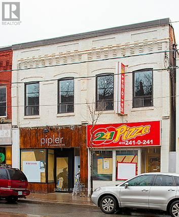A building with a pizza shop on the ground floor.