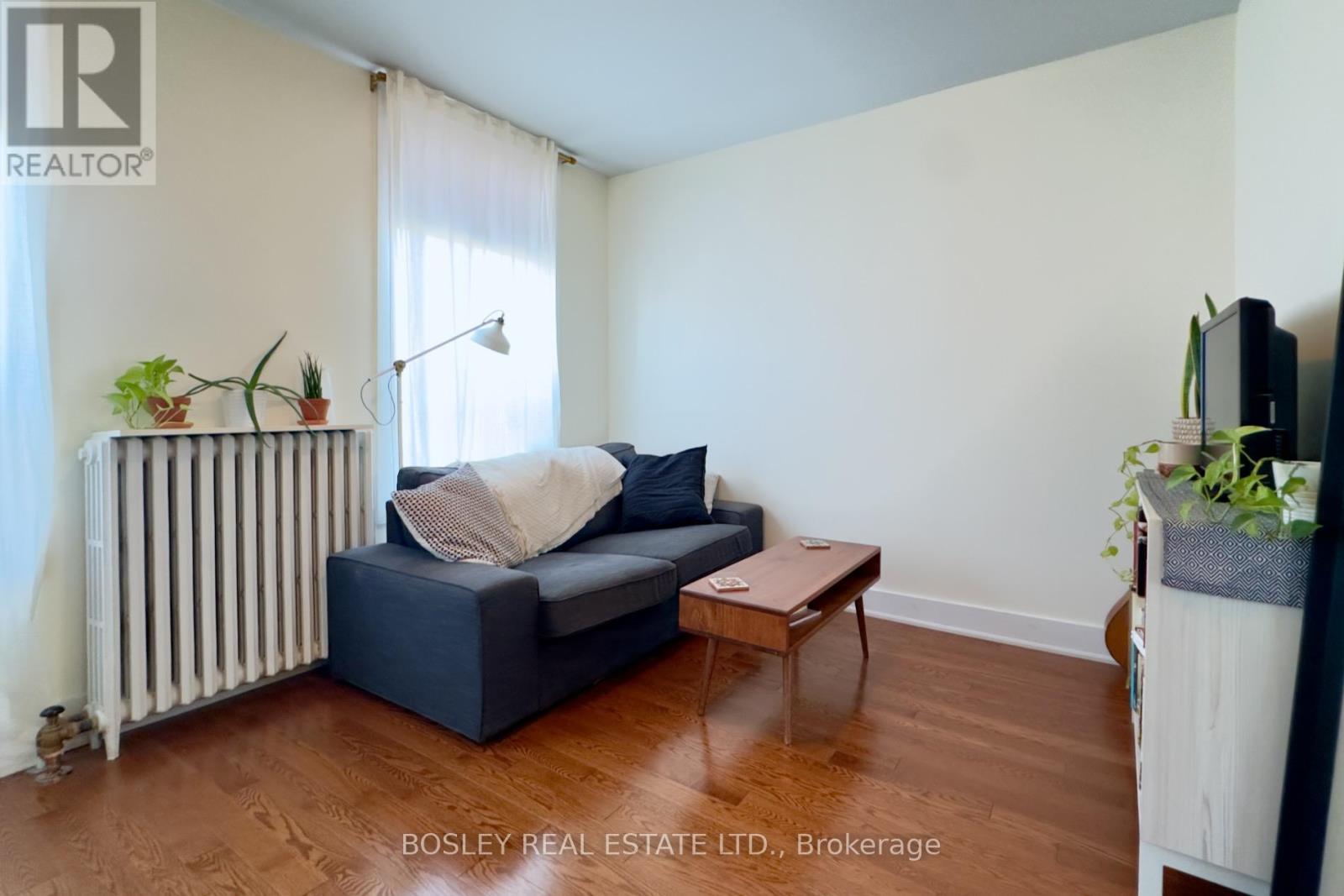 A living room with a blue couch and a wooden coffee table.