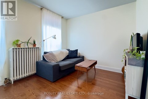 A living room with a blue couch and a wooden coffee table.