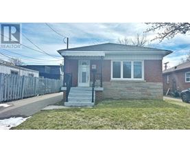 A house with a brick facade and a white door is for sale.