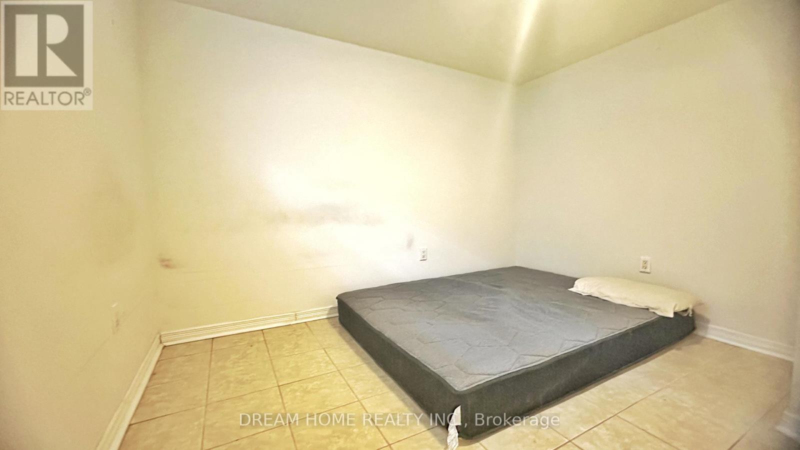 A bedroom with a bed and a mattress in it.