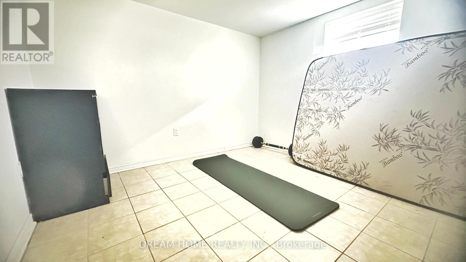 A yoga mat is placed on the floor in a room with a wallpapered wall.