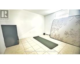 A yoga mat is placed on the floor in a room with a wallpapered wall.