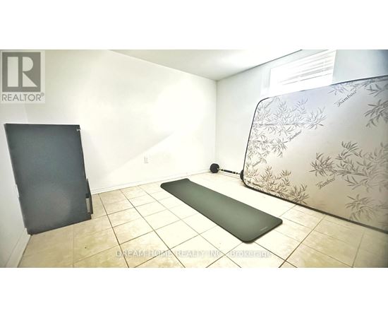 A yoga mat is placed on the floor in a room with a wallpapered wall.