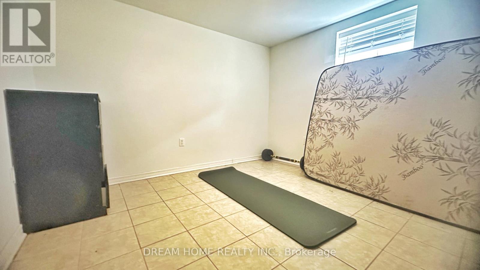 A yoga mat is placed on the floor of a room with a wallpapered wall.