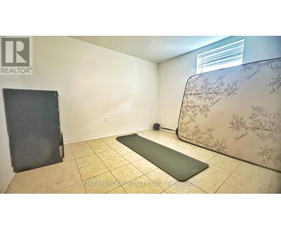 A yoga mat is placed on the floor of a room with a wallpapered wall.